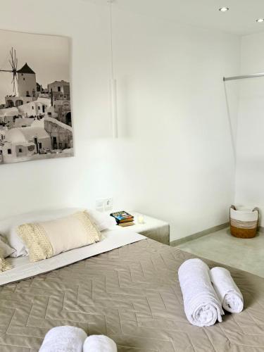 a bedroom with a bed with towels on it at Fira Heart Studios in Fira