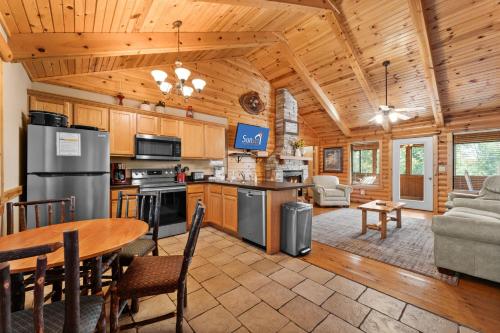 a kitchen and living room in a log cabin at Ozarks Oasis cabin in Branson
