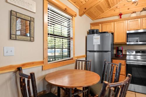 a kitchen with a table and a refrigerator at Ozarks Oasis cabin in Branson