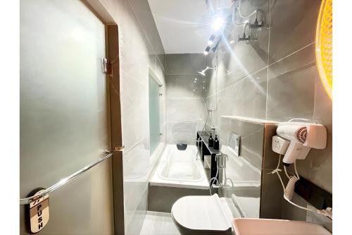 a small bathroom with a toilet and a sink at Winterline Vista in Rānīkhet