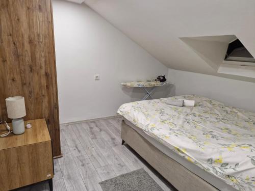 a small bedroom with a bed and a table at Apartment close to the sea in the most central of city in Antalya