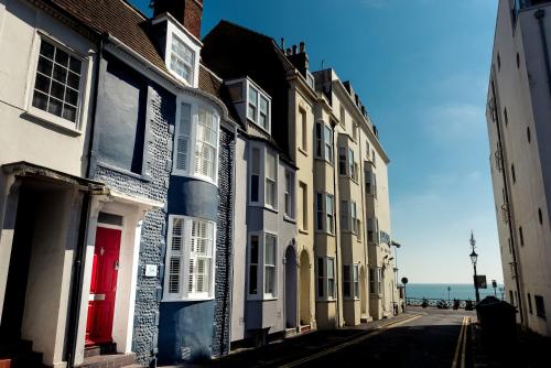 a row of houses on a street next to the ocean at The Beach House in Brighton & Hove