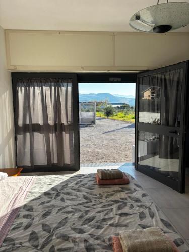 a bedroom with a large glass door with a view at Red House- Camera per quattro in Montecorvino Rovella