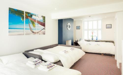 a living room with two beds and a couch at The Beach House in Brighton & Hove