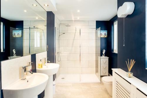 a bathroom with two sinks and a shower at The Beach House in Brighton & Hove