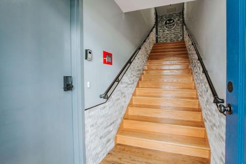a hallway with wooden floors and a stair case at Fishersville Oasis in Fishersville