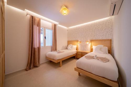 een slaapkamer met twee bedden en een raam bij Villa Moon in Tías