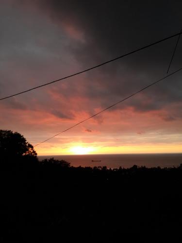 a sunset over the ocean with a power line at BIS-A Guesthouse in Makhinjauri