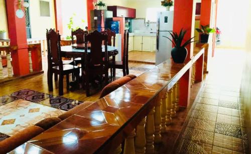 a kitchen and dining room with a long table at Z House of Guests 6- Mambago B, Samal Davao Del Norte in Samal