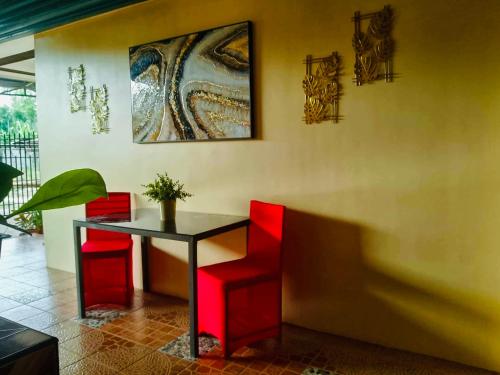 a dining room with red chairs and a table at Z House of Guests 6- Mambago B, Samal Davao Del Norte in Samal