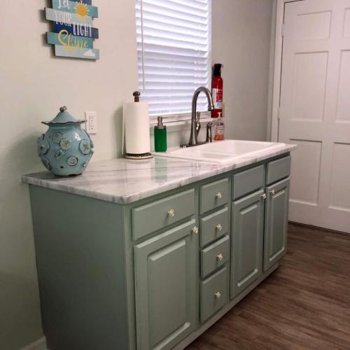 a kitchen with a sink and a counter top at Quiet-Clean-Cottage-Dogs Kitchen in Tallahassee