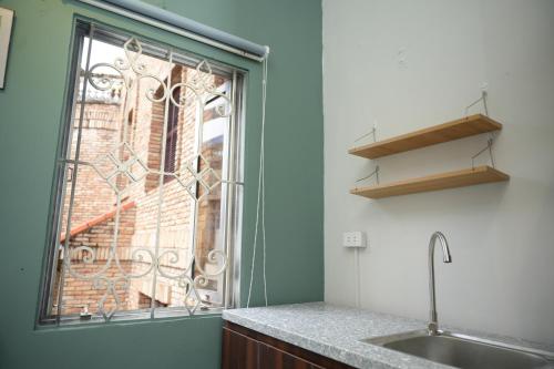 a kitchen with a window next to a sink at Four Seasons Serenity Studio - SDhousing branch in Hanoi