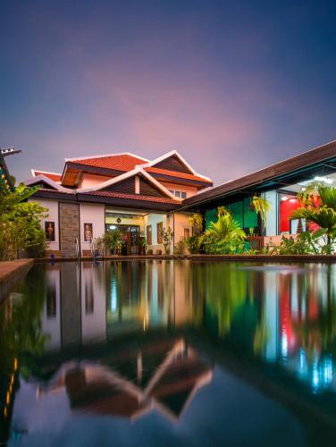 a house with a swimming pool in front of it at SATTA Private Pool Grill & Chill Villa in Siem Reap