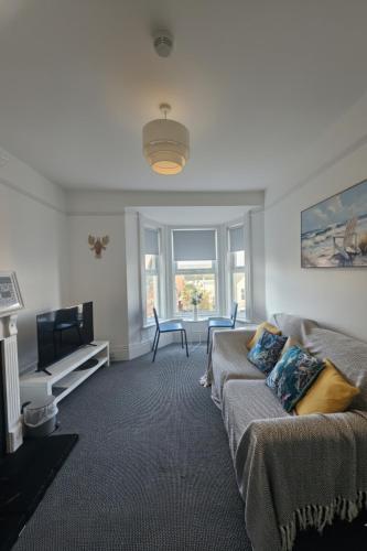 a living room with a couch and a television at The Exmouth Hideaway in Exmouth