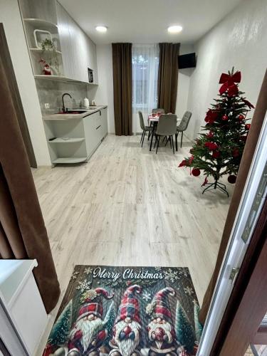 a living room with a christmas tree and a kitchen at Зелений ретрит in Skole