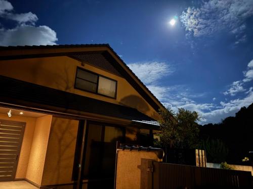 a house with the moon in the sky at The Nine Kings in Imabari
