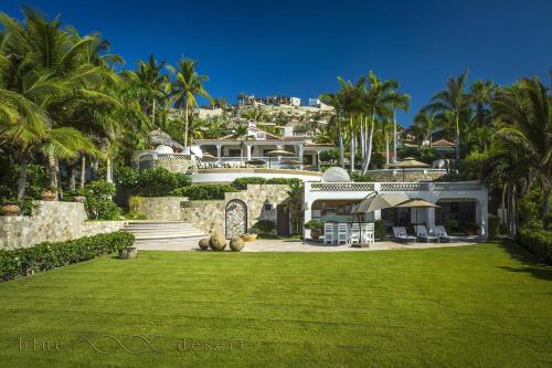 a house with a green lawn in front of it at Casa Edwards in San José del Cabo