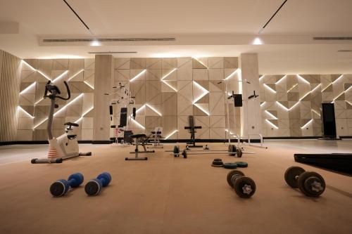 a gym with dumbbells on the floor in a room at سكينة هاوس in Riyadh