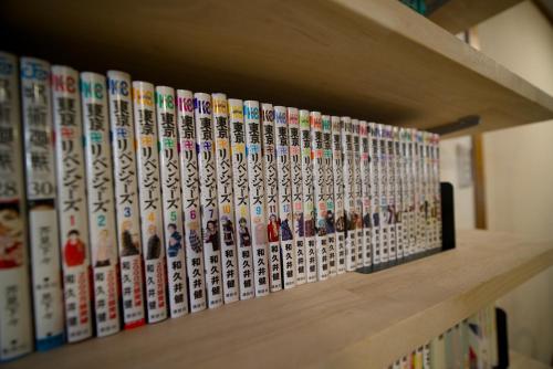 a shelf with a bunch of video game books at 漫画のある家 in Yamatokoriyama