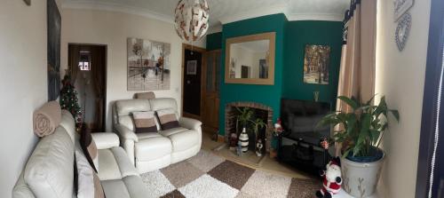 a living room with a couch and a fireplace at Ruckledge Terrace in Skegby