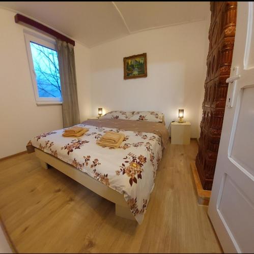 a bedroom with a bed and a window with two lamps at Cabana Lunca in Lunca Ampoiţei