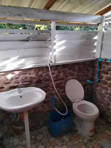 a bathroom with a toilet and a sink at Island Life Bungalows in Ko Khan