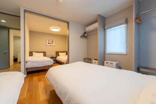 Postel nebo postele na pokoji v ubytování Mori Sapporo