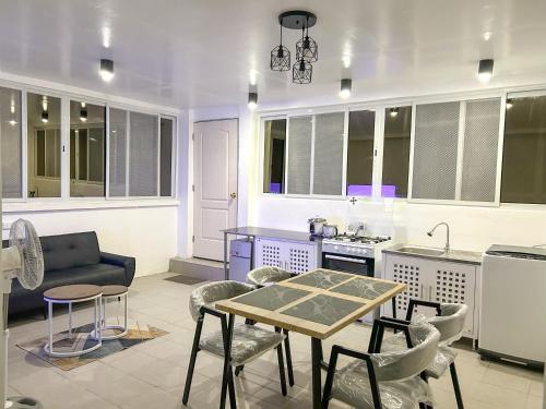 a kitchen with a table and chairs in a kitchen at EC HomeStay in Tarlac