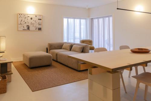 a living room with a couch and a table at Apartamento Sacadura Cabral - a 2 min da praia in Vila do Conde