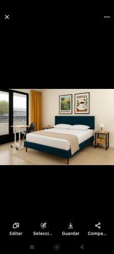 a bedroom with a bed and a desk and a bed sidx sidx sidx at colibrí Hostel in Armenia