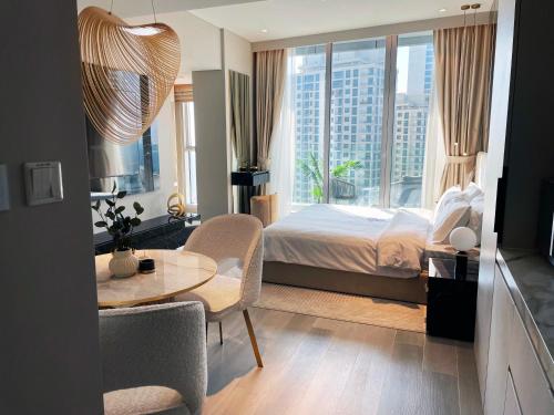 a bedroom with a bed and a table and chairs at Casa Royale Vacation Home - Dubai Marina in Dubai