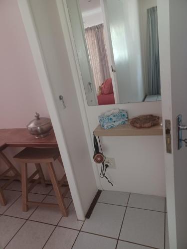 a hallway with a table and a mirror at The Roaches in White River