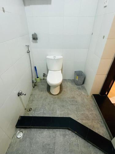 a small bathroom with a toilet in a stall at Traveler's Cottage in Unawatuna