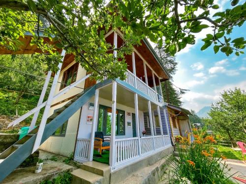 a house with a porch and stairs to it at Euphoria Shangarh - Hostel in Shangarh