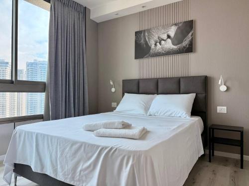 Ένα ή περισσότερα κρεβάτια σε δωμάτιο στο Sea Breeze Studios