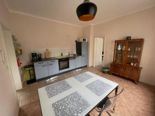 a kitchen with a table and a counter top at Ferienwohnung Lahann in Saalfeld