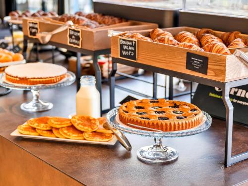uma padaria com tortas e doces num balcão em B&B Hotel Milano Aosta em Milão