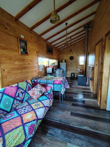 a room with couches and tables in a cabin at Cabañas y Artesanías El Roble in Dalcahue