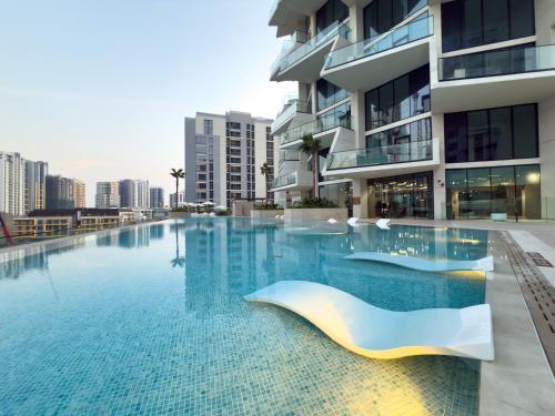 a swimming pool in front of a building at Private Pool - Amazing 1BR Apartment in JVC in Dubai