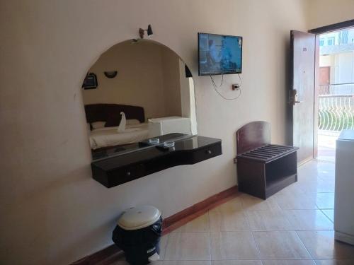 a bathroom with a mirror on the wall at Eiffel Hotel Hurghada in Hurghada