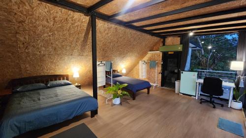 a bedroom with a bed and a desk in a room at Seven 50s in Pai