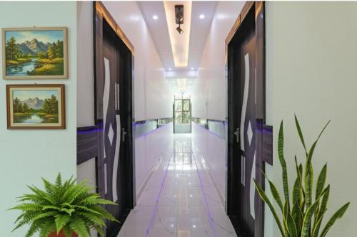 a corridor in a building with a hallway at FabHotel Lumbini International - Nr Sarnath Museum in Varanasi