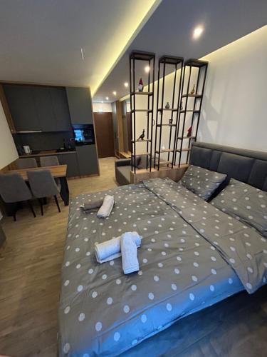 a bedroom with a bed with two towels on it at B8 Residence hill in Kopaonik