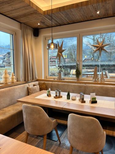 a restaurant with a large wooden table and chairs at Landgasthof Bierfriedl in Pruggern