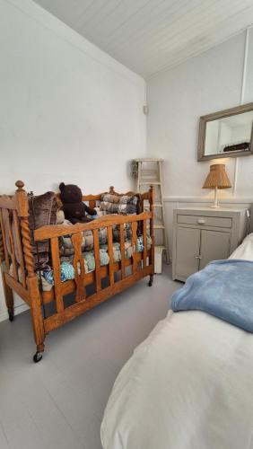 a bedroom with a bed with a teddy bear on it at The Ark Holiday Home in Stanford