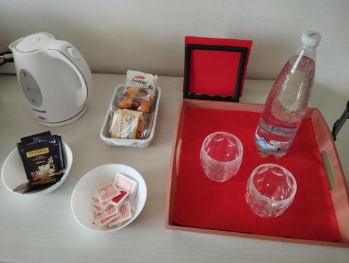 a red tray with a bottle of water and some food at Denisoph Apartment in Lucca