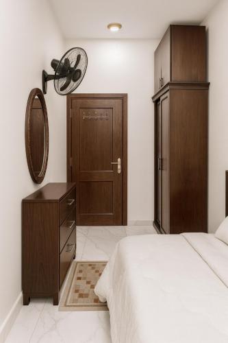a bedroom with a bed and a mirror and a closet at Al FAHAD private apartments for rent in Luxor