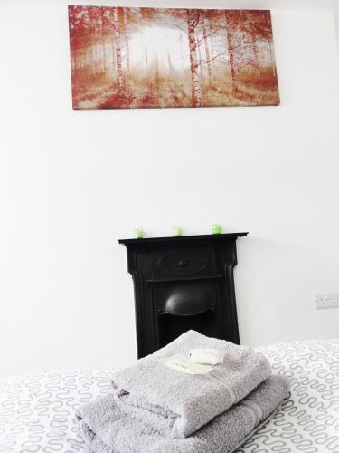 a bed with two towels sitting on top of it at Camden Habitat in London