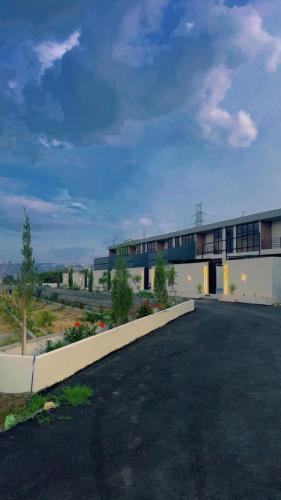 a building with a parking lot in front of it at albaha harmony resort in Al Baha