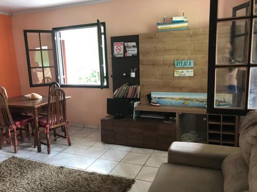 a living room with a table and a dining room at Camping-Casa Saco do Ceu in Saco do Ceu